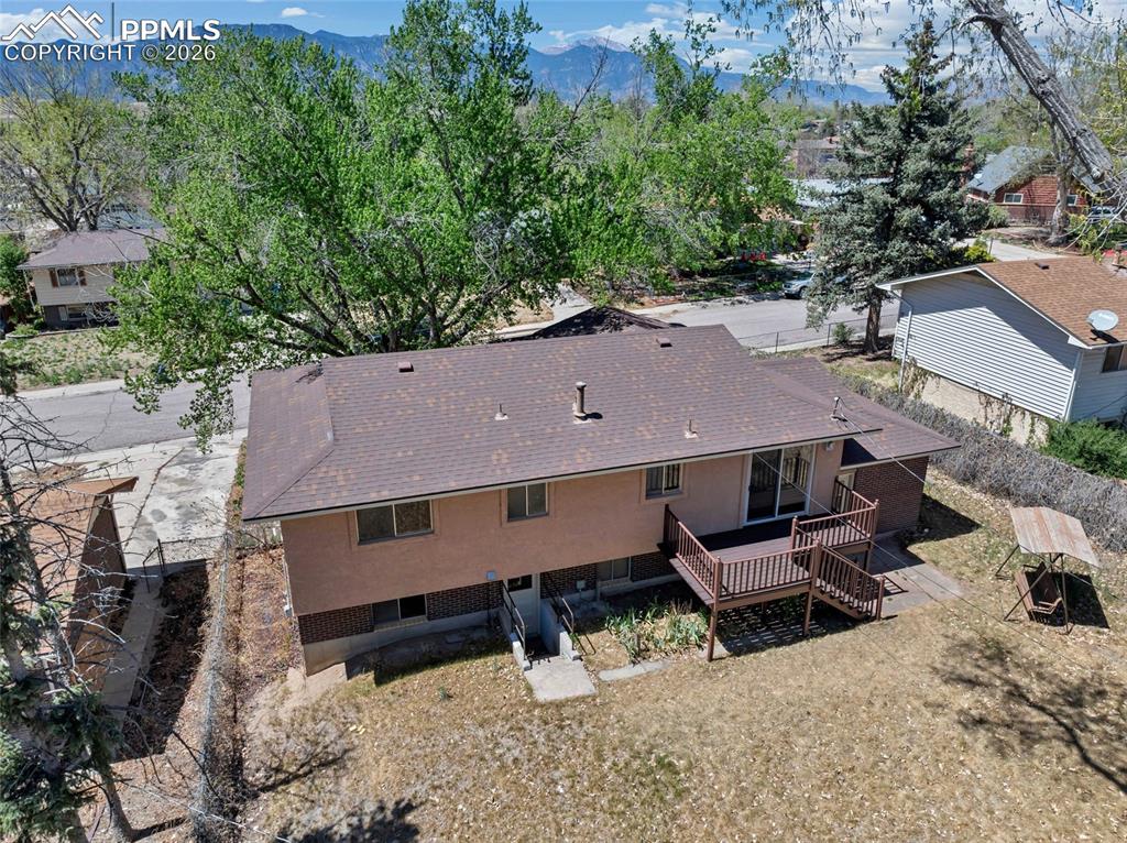 Image 32 of 36: Rear elevation featuring a multi-level wood deck, ground-level patio, and s