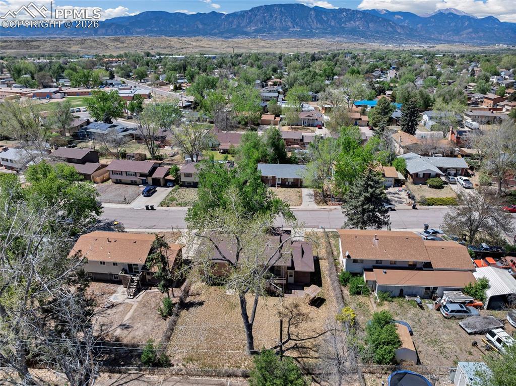 Image 35 of 36: Expansive aerial panorama showcasing a residential neighborhood with a dist