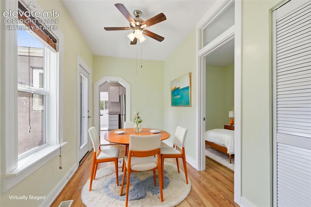 Image 10 of 40: Virtually staged dining area with pine hardwood flooring, arched opening, a