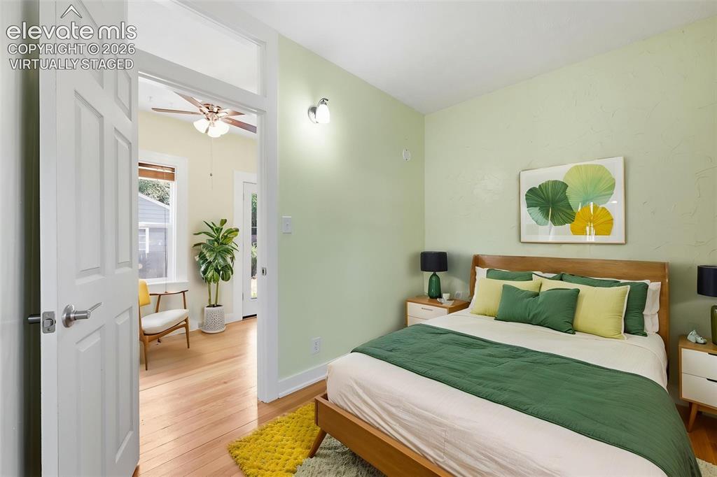 Image 13 of 40: Virtually staged main-floor bedroom with pine hardwood flooring throughout,