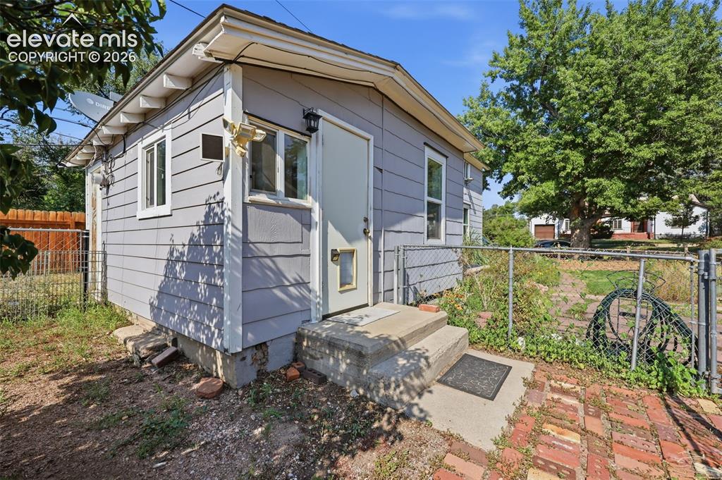 Image 31 of 40: Exterior featuring, horizontal siding, white trim windows, a side door yard