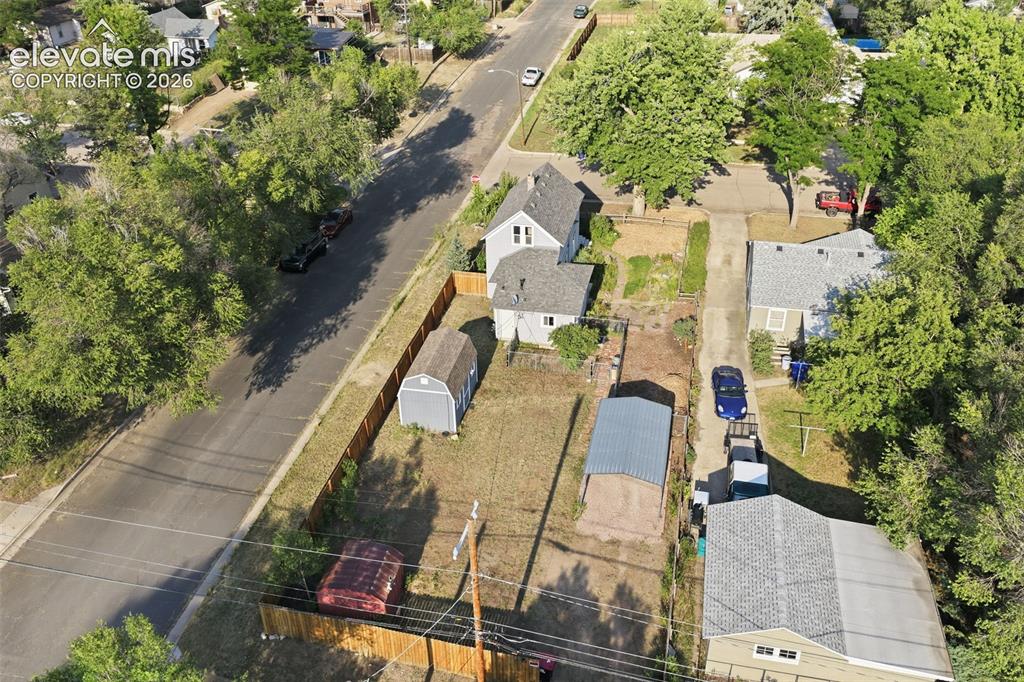 Image 37 of 40: Property featuring a detached shed, an additional smaller red shed, a metal