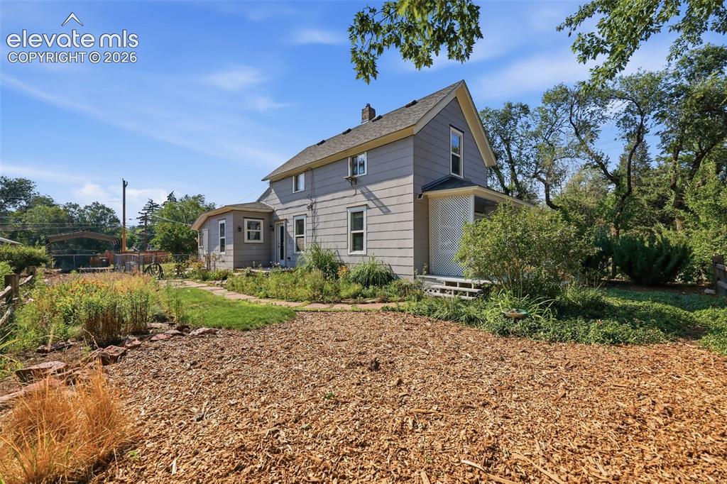 Image 4 of 40: Exterior featuring flowerbeds, horizontal siding and white trim windows.