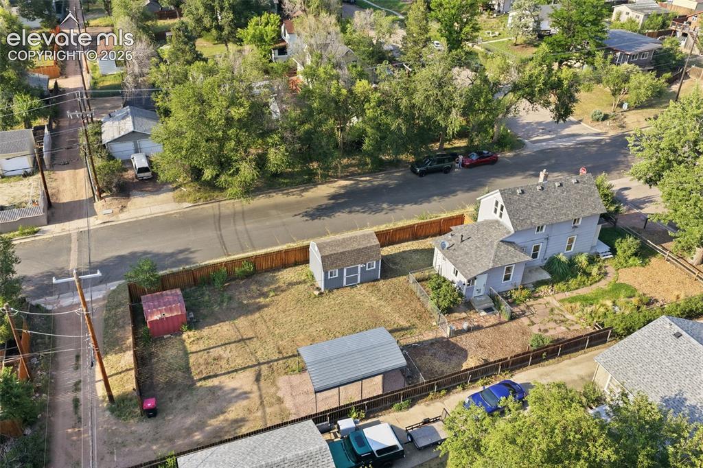 Image 5 of 40: Property featuring a detached shed, an additional smaller red shed, a metal