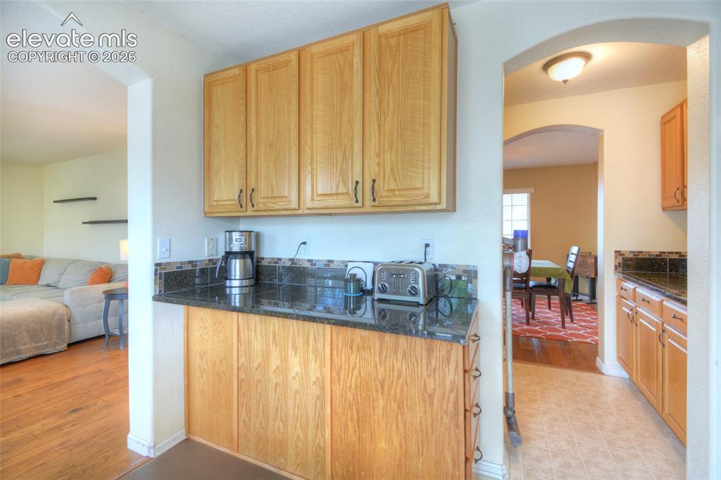Image 13 of 35: Spacious kitchen with a generous amount of cabinetry and granite counters!