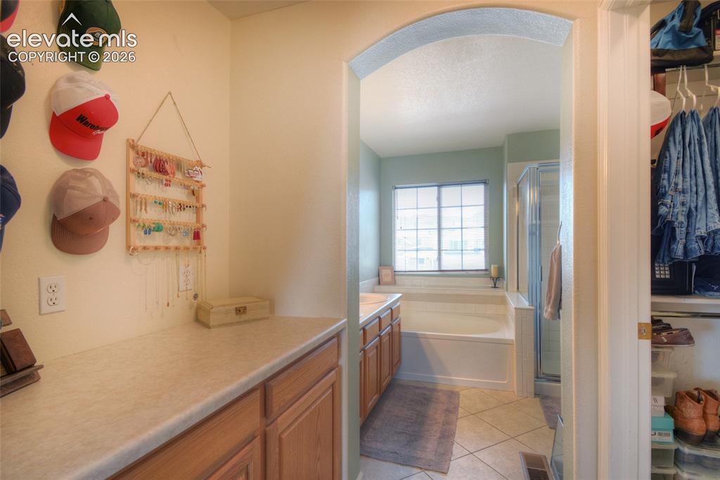 Image 22 of 35: 5 piece bath in the primary bedroom to include a separate toilet area and w