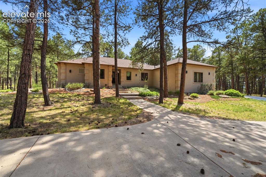 Image 1 of 40: Spacious single-story residence featuring a neutral stucco exterior and an