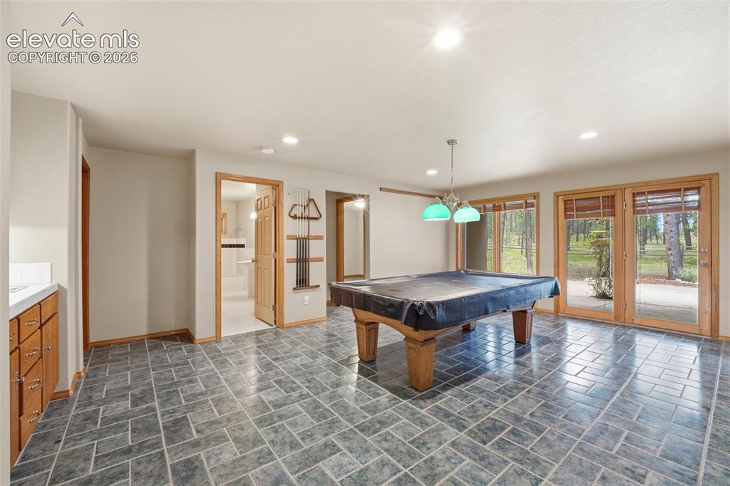 Image 27 of 40: Spacious room featuring patterned gray floor tile and multiple sets of Fren