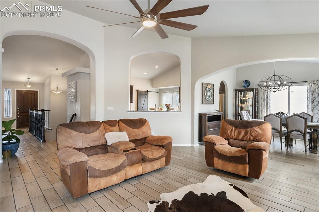 Image 18 of 41: Living area featuring ceramic tile flooring, vaulted ceilings, and a ceilin