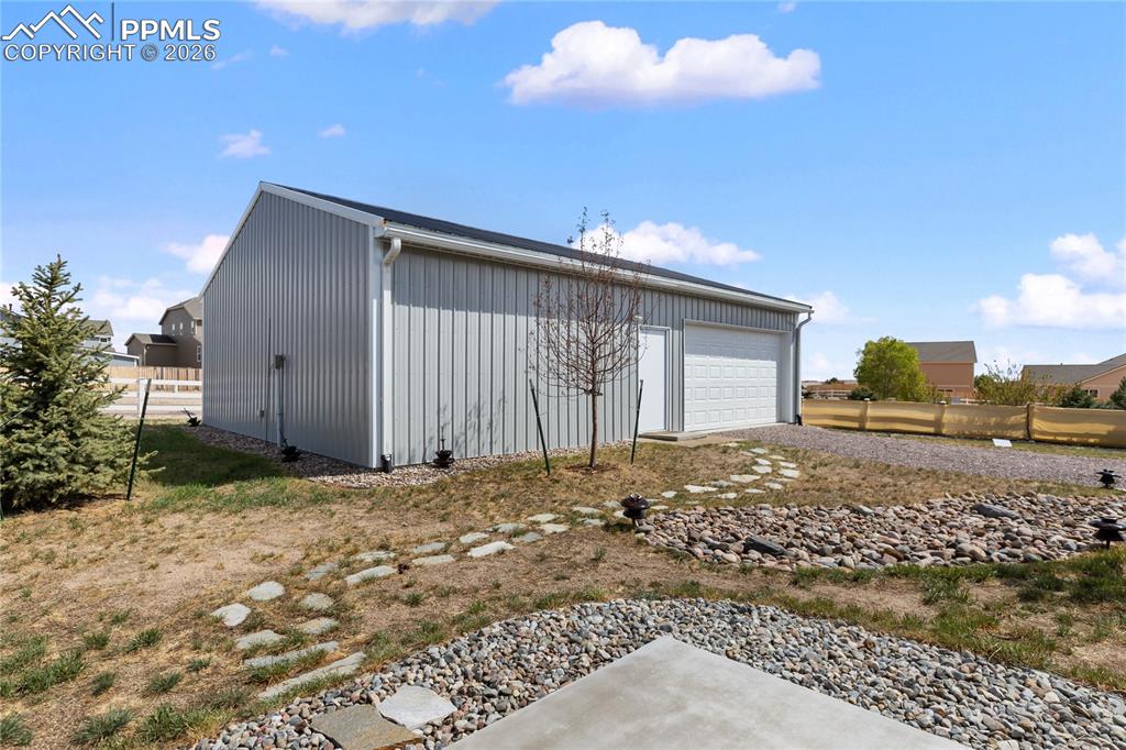 Image 2 of 41: Insulated shop with 240V power, overhead door, and gravel access