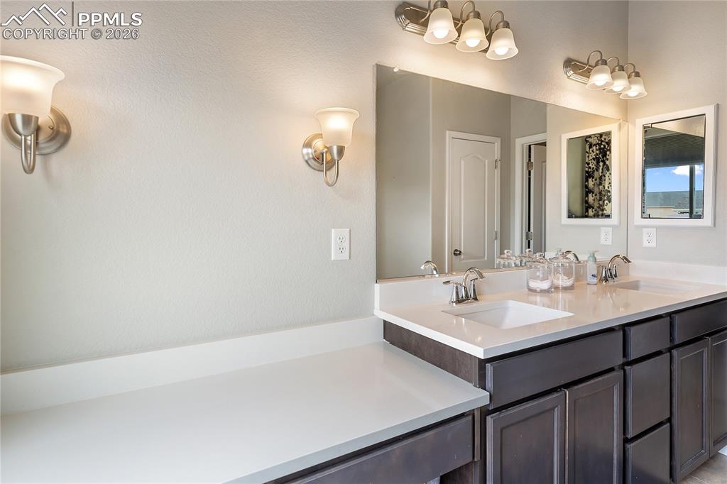 Image 22 of 41: Double vanity primary bathroom with connected walk-in closet