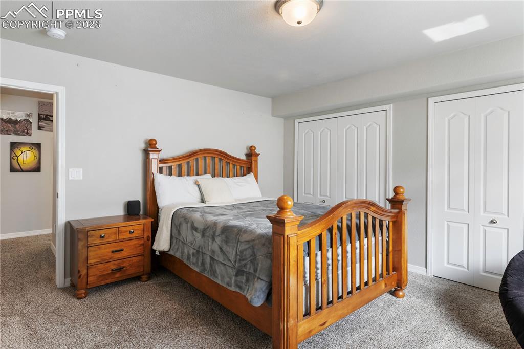 Image 29 of 41: Spacious bedroom with ample room and clean, modern finishes