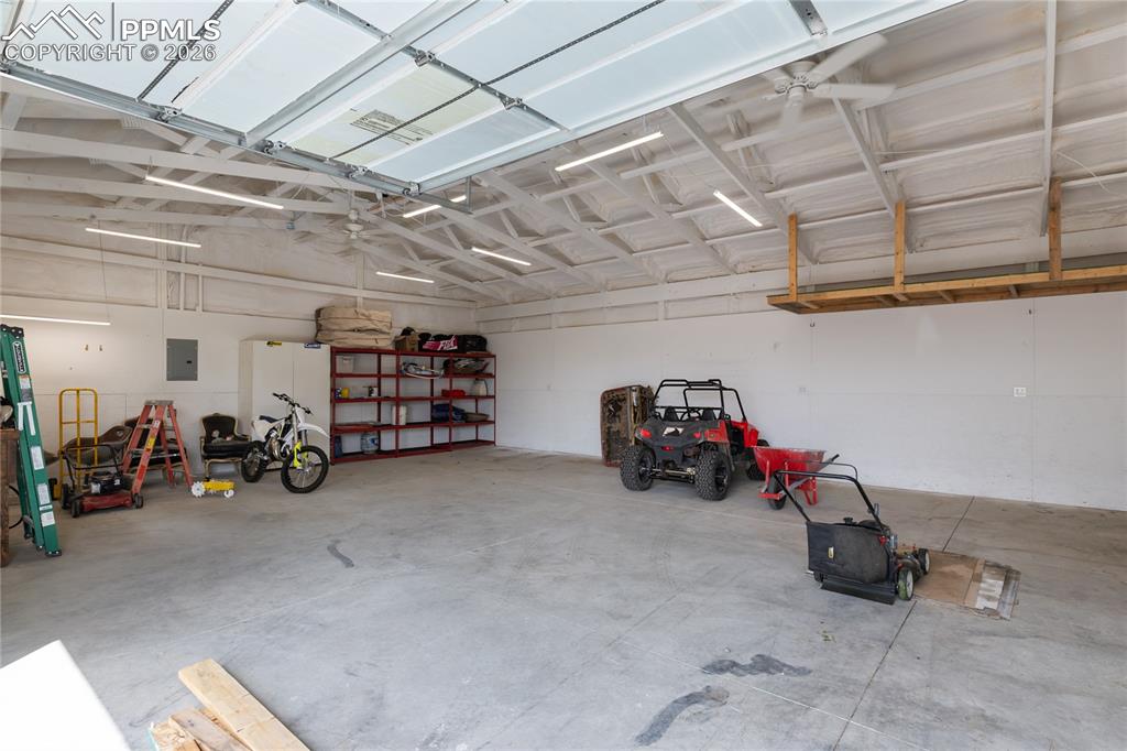 Image 37 of 41: Spacious insulated shop with high ceilings and room for vehicles, storage, 