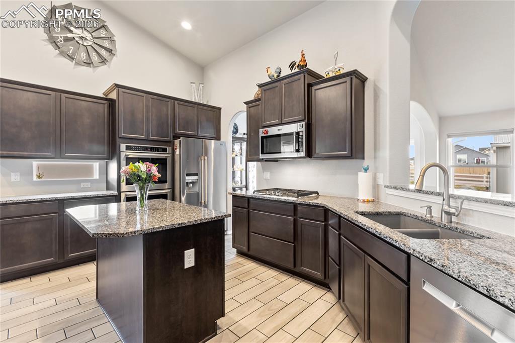 Image 4 of 41: Contemporary kitchen featuring ceramic tile flooring, granite countertops, 