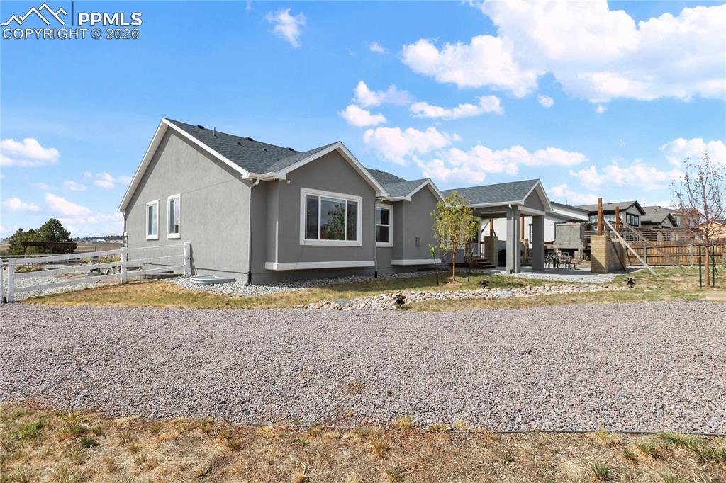 Image 40 of 41: Rear exterior showcasing a covered patio with concrete flooring