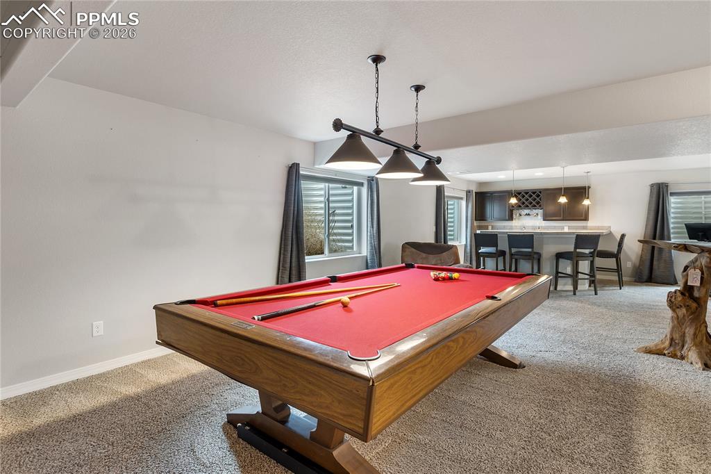 Image 6 of 41: Large basement rec room with versatile living space