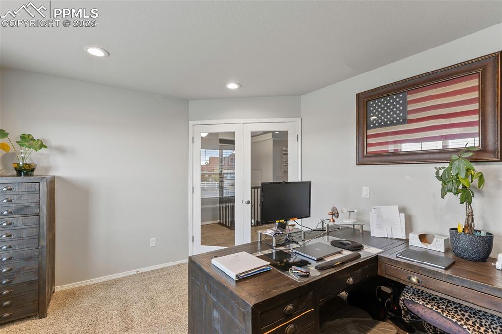Image 8 of 41: Office with double French doors with glass panels, recessed ceiling lightin