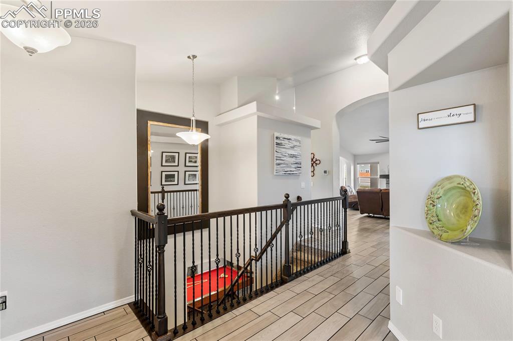 Image 9 of 41: Entryway featuring ceramic tile flooring, wrought iron balusters, a dark wo