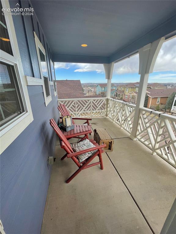 Image 13 of 27: Covered outdoor balcony with a patterned railing, recessed ceiling light, a