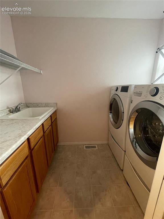 Image 14 of 27: Utility room featuring a built-in cabinet with a sink, laminate countertop,