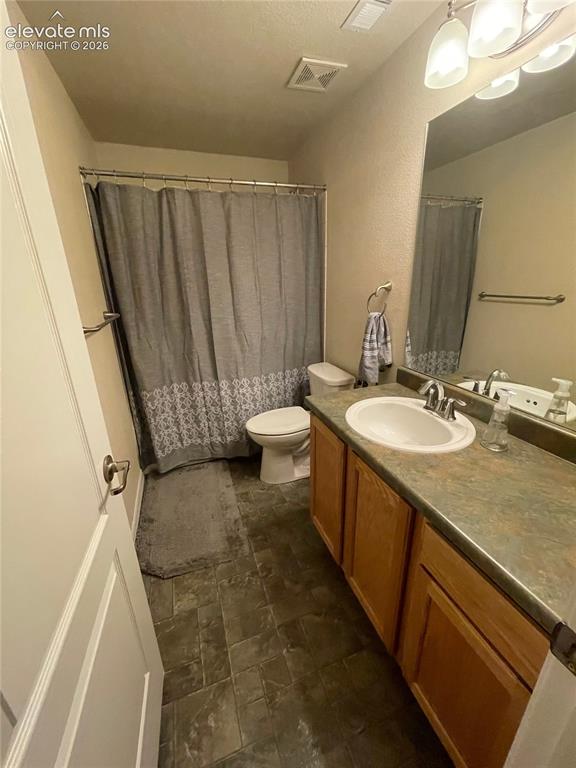 Image 16 of 27: Bathroom featuring tile flooring, a built-in vanity with cabinetry, an inte