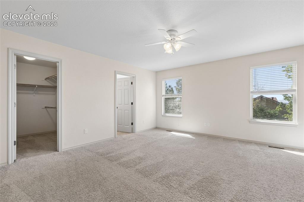 Image 16 of 34: Primary suite retreat featuring a large walk-in closet and ensuite 5-piece 