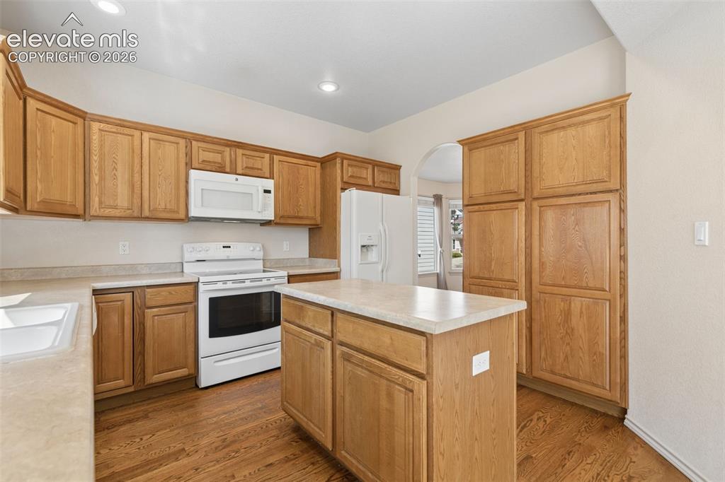 Image 9 of 34: The well-equipped kitchen features an island, ample storage space, and hard