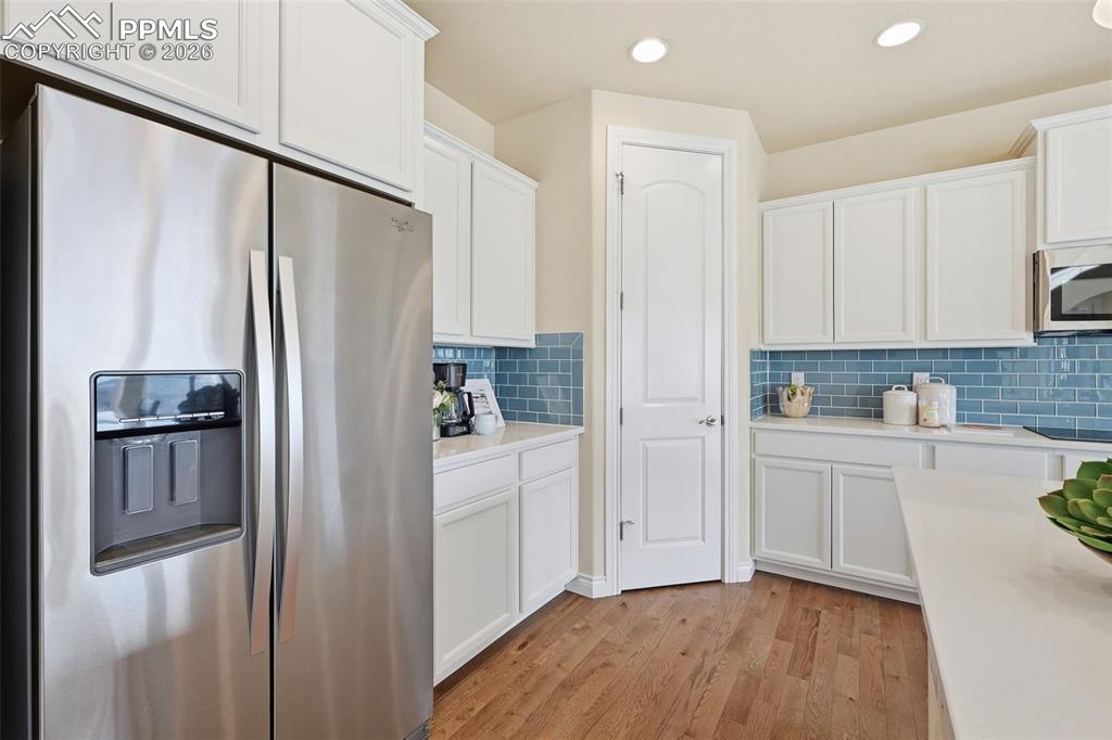 Image 25 of 45: Gourmet Kitchen With Walk In Pantry And Stainless Steel Appliances And Hard