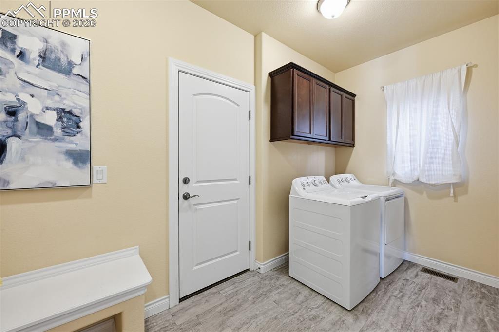 Image 26 of 45: Laundry Room Area Coming In From Garage.  Washer and Dryer Remain.