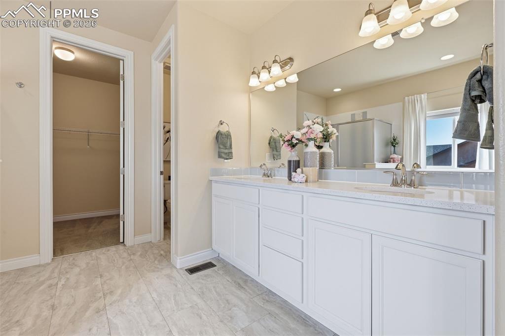 Image 30 of 45: Primary Bathroom, View Towards Large Walk In Closet and Private Water Close