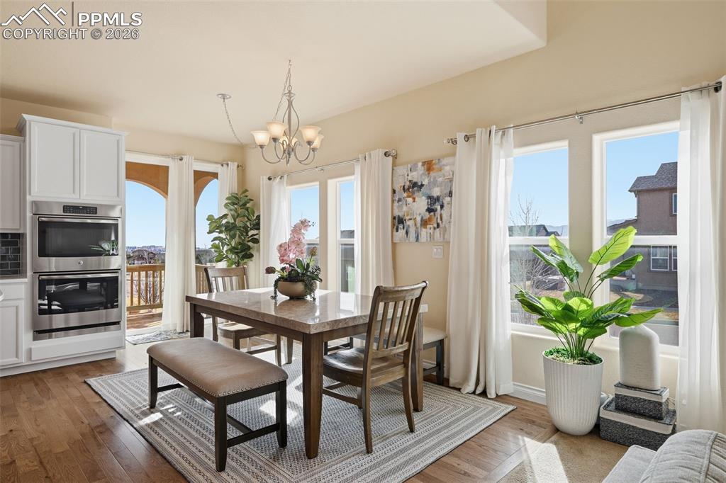 Image 5 of 45: Dining Area With Walkout To Deck And Back Yard Stairs. Views Of Pikes Peak 