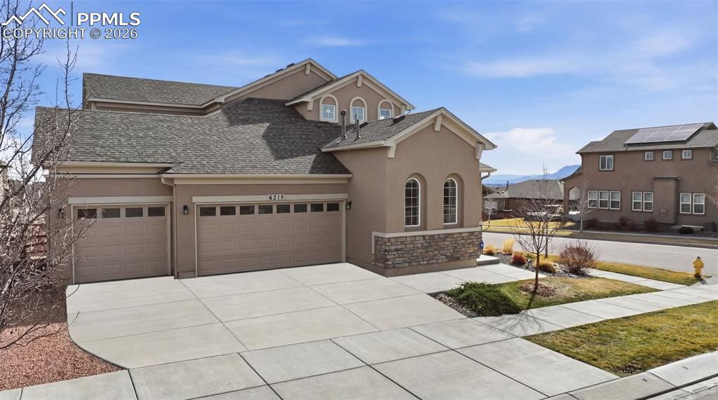 Image 7 of 45: Front View Of Home And 3 Car Garage