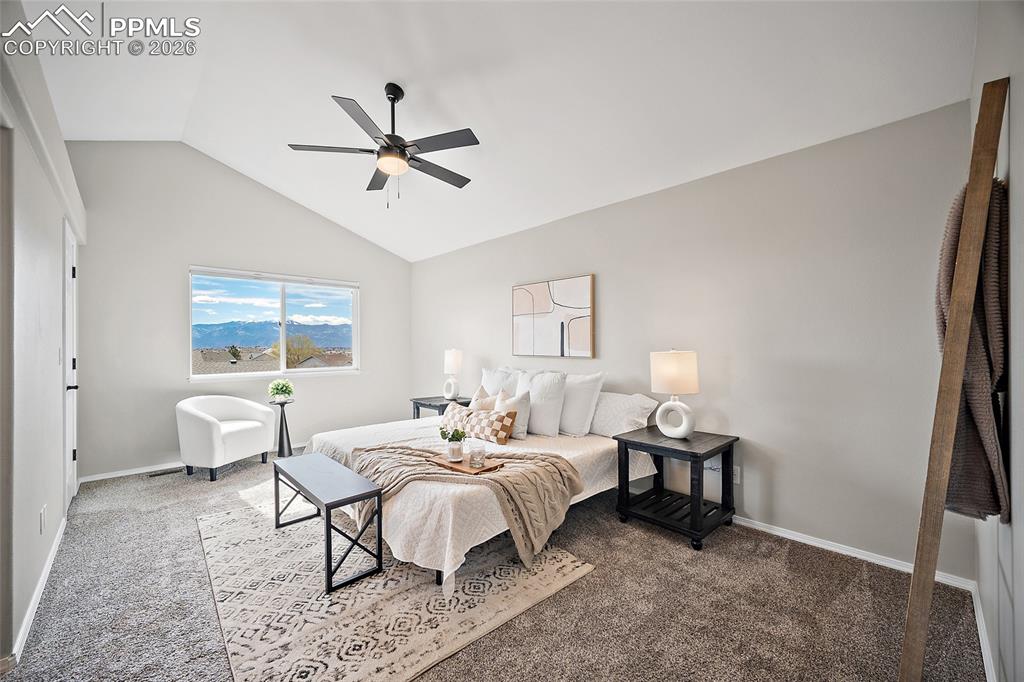 Image 15 of 46: Bedroom with carpet flooring, a ceiling fan, and vaulted ceiling