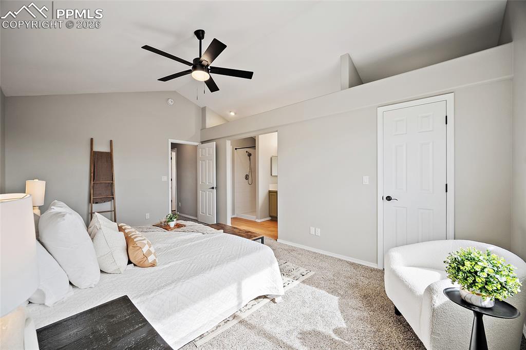 Image 17 of 46: Bedroom featuring lofted ceiling, light carpet, a ceiling fan, and connecte