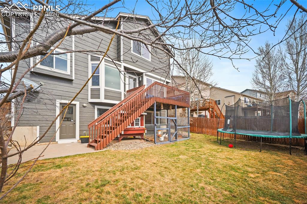 Image 27 of 46: Back of house featuring a trampoline and a patio area