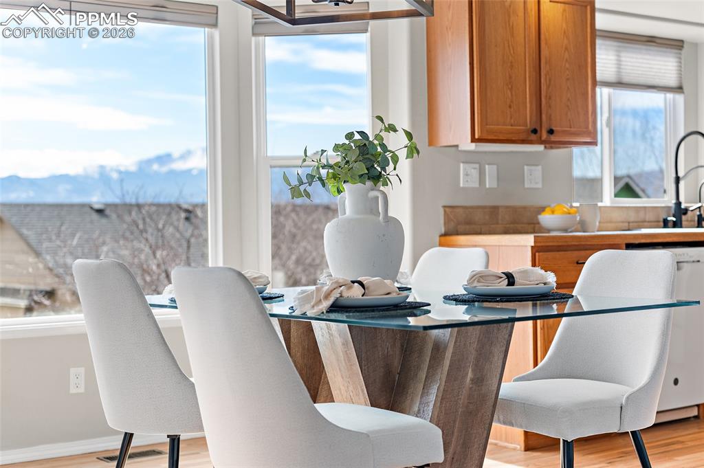 Image 34 of 46: Dining room with light wood finished floors and baseboards