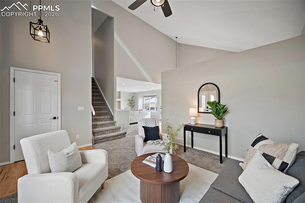 Image 41 of 46: Living room with lofted ceiling and ceiling fan