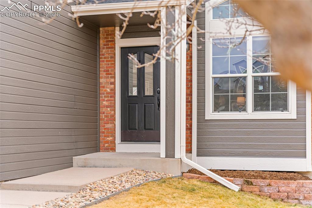 Image 5 of 46: Entrance to property featuring brick siding