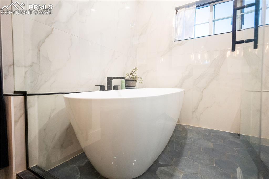 Image 13 of 44: Bathroom with a soaking tub