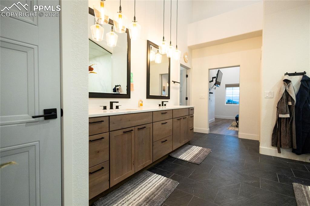 Image 14 of 44: Bathroom featuring double vanity and baseboards