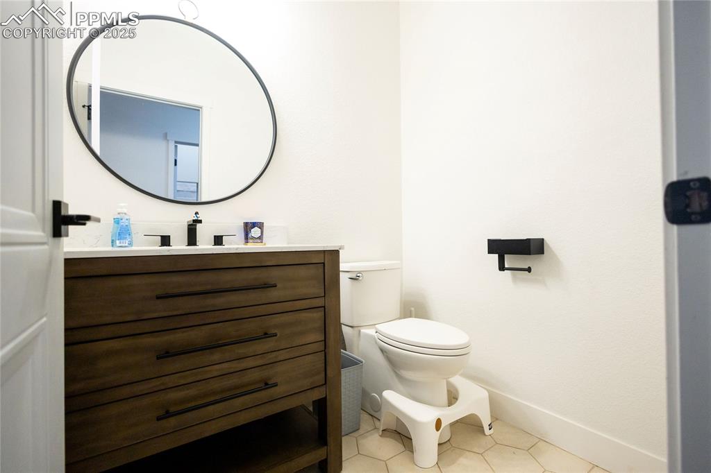Image 21 of 44: Half bath featuring vanity and light tile patterned flooring