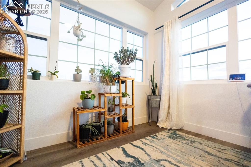Image 24 of 44: Sitting room featuring wood finished floors and a textured wall