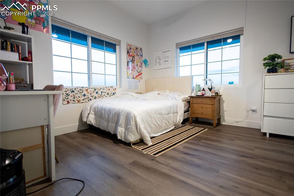 Image 25 of 44: Bedroom 2 featuring dark wood finished floors and baseboards