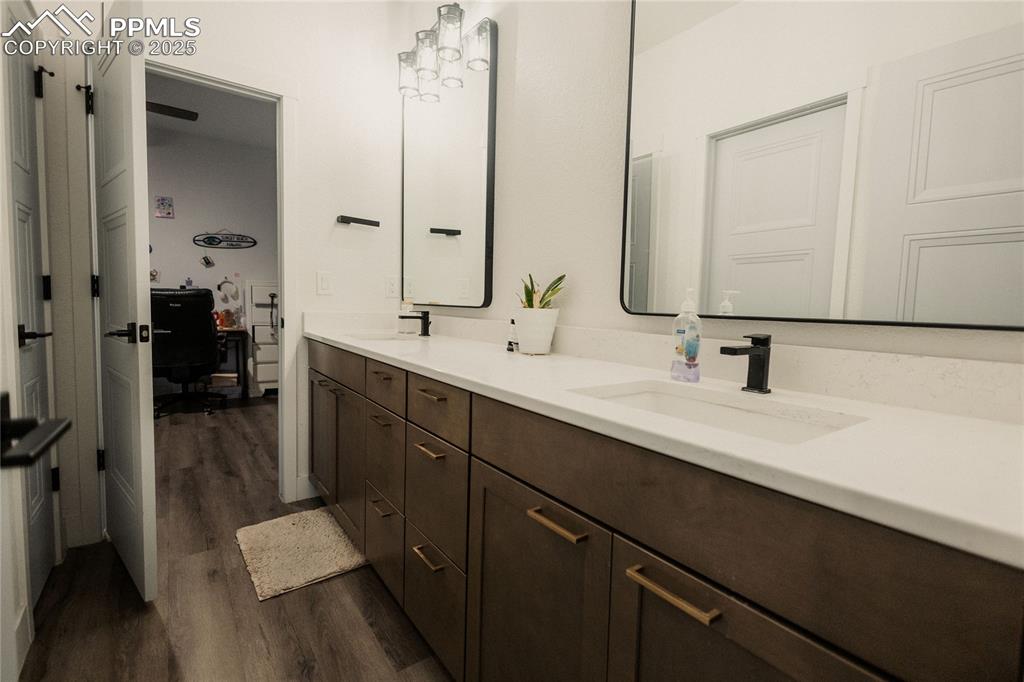 Image 26 of 44: Full bath with dark wood-style floors and double vanity