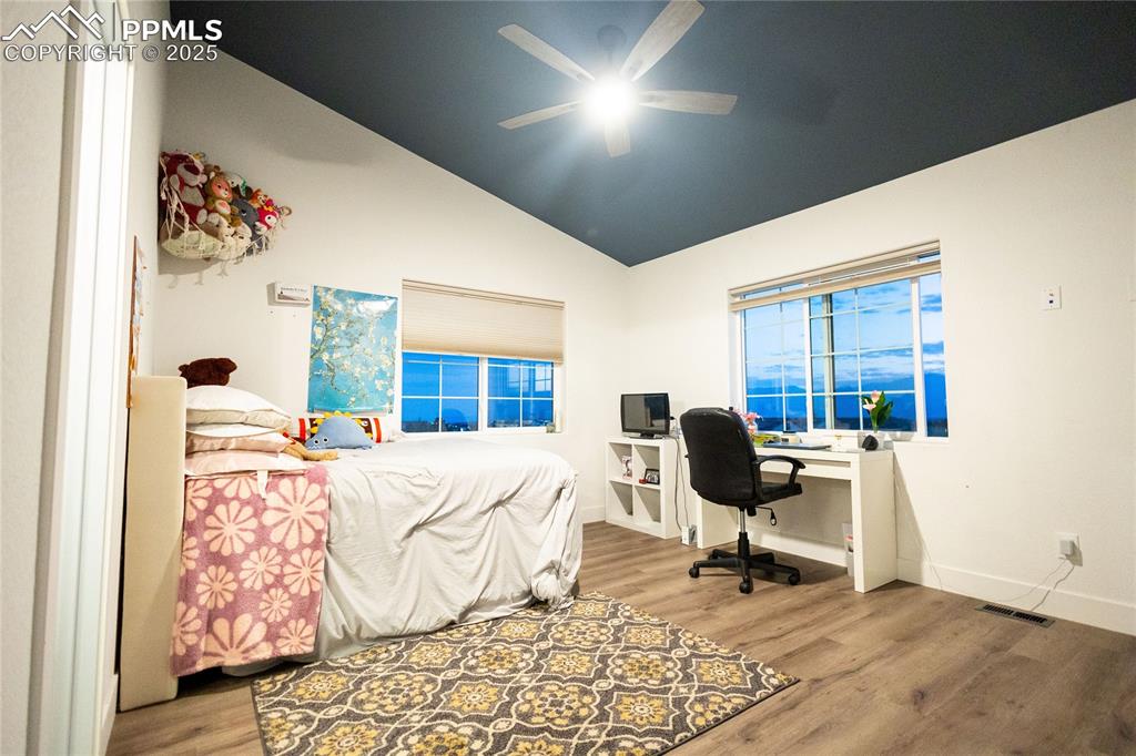 Image 27 of 44: Bedroom 3 with lofted ceiling, light wood-style floors, a desk, and ceiling