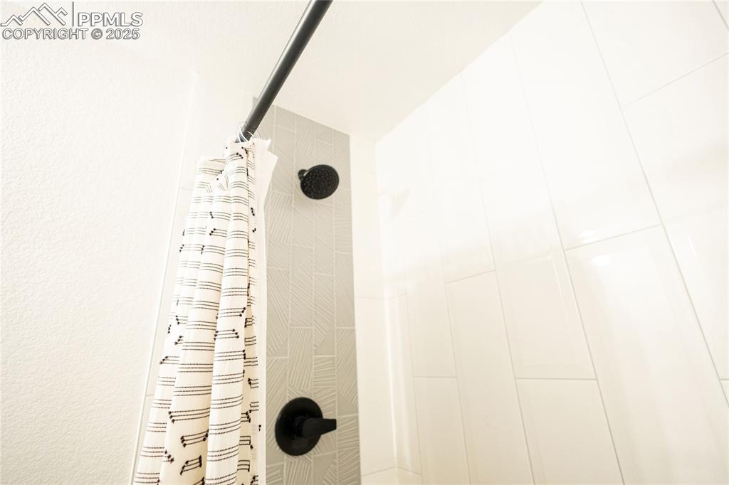 Image 28 of 44: Bathroom view of tiled shower