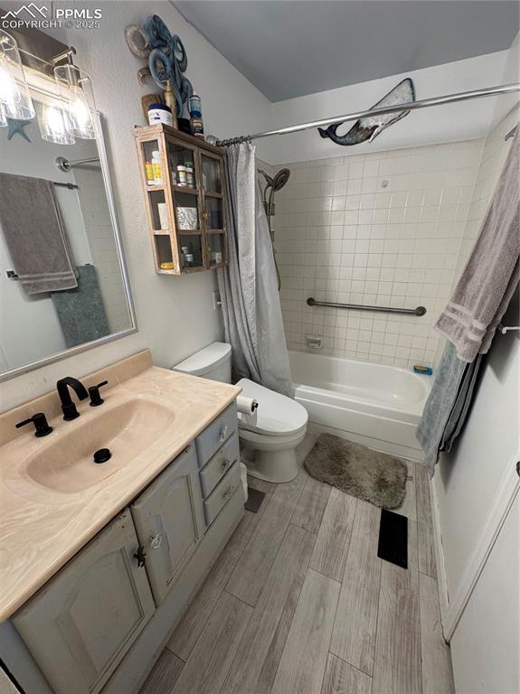 Image 16 of 22: Full bathroom with shower / bathtub combination with curtain, vanity, and l