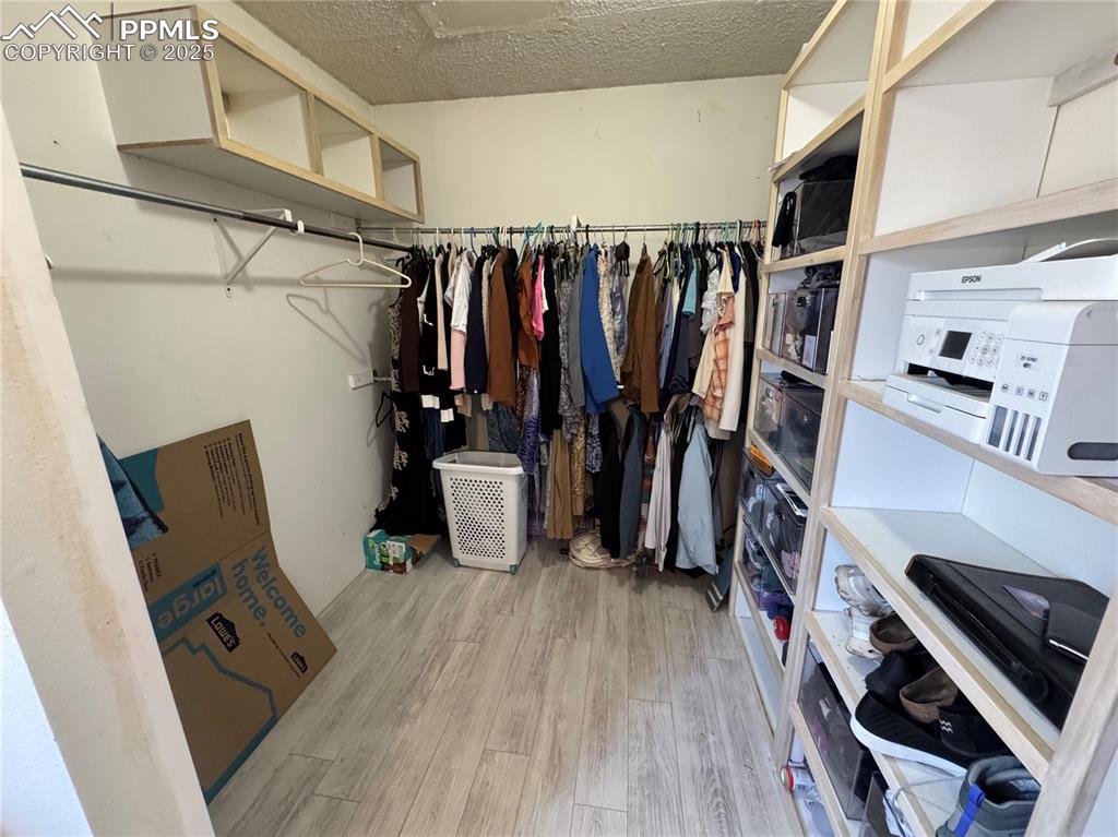 Image 18 of 22: Walk in closet featuring light wood-type flooring