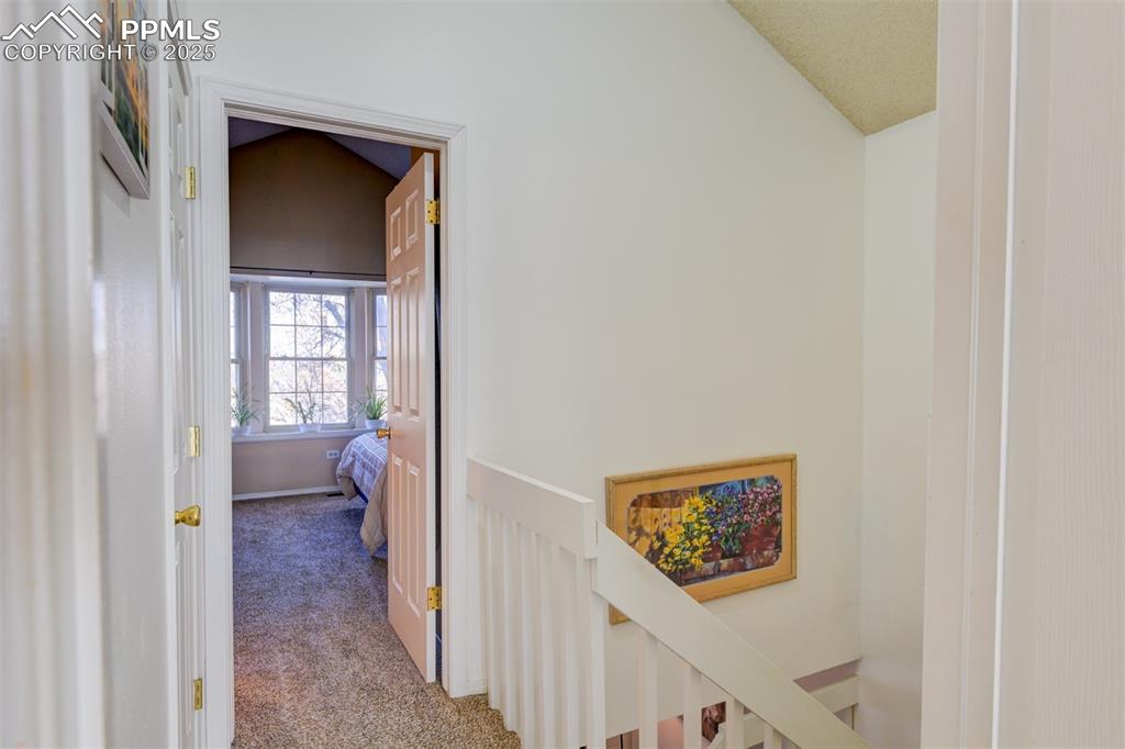 Image 17 of 25: Hall leading to the 2nd bedroom on the upper level. 