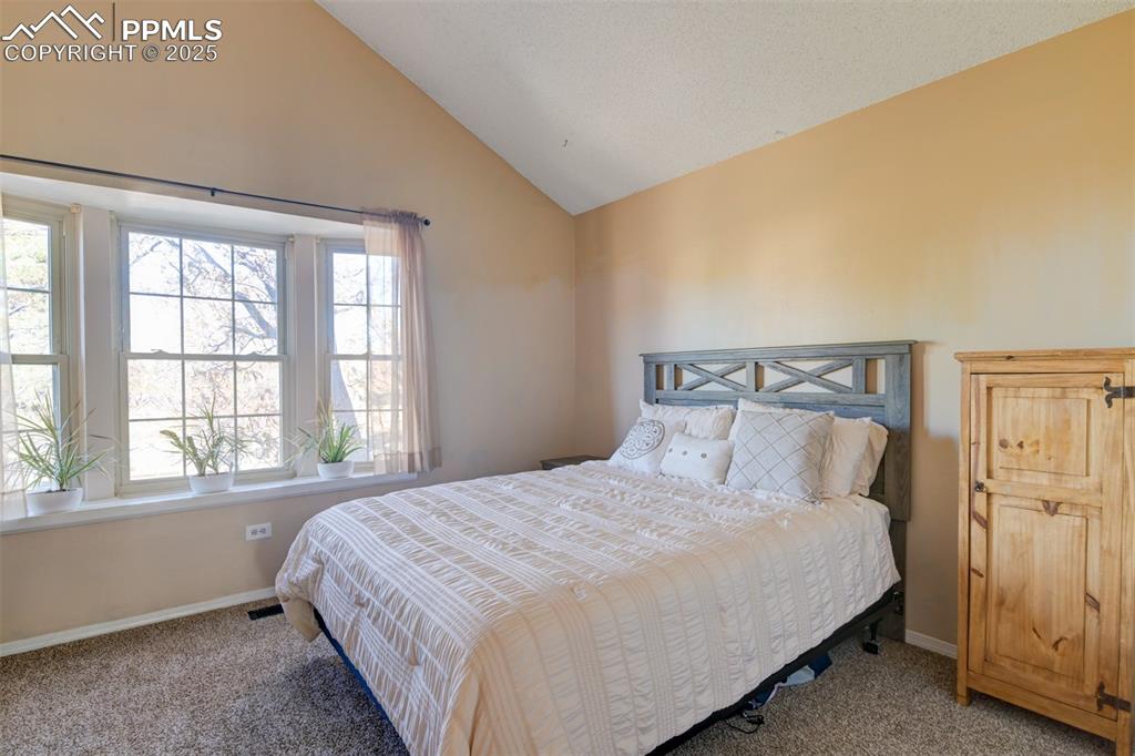 Image 18 of 25: 2nd bedroom with lofted ceiling and beautiful bay window